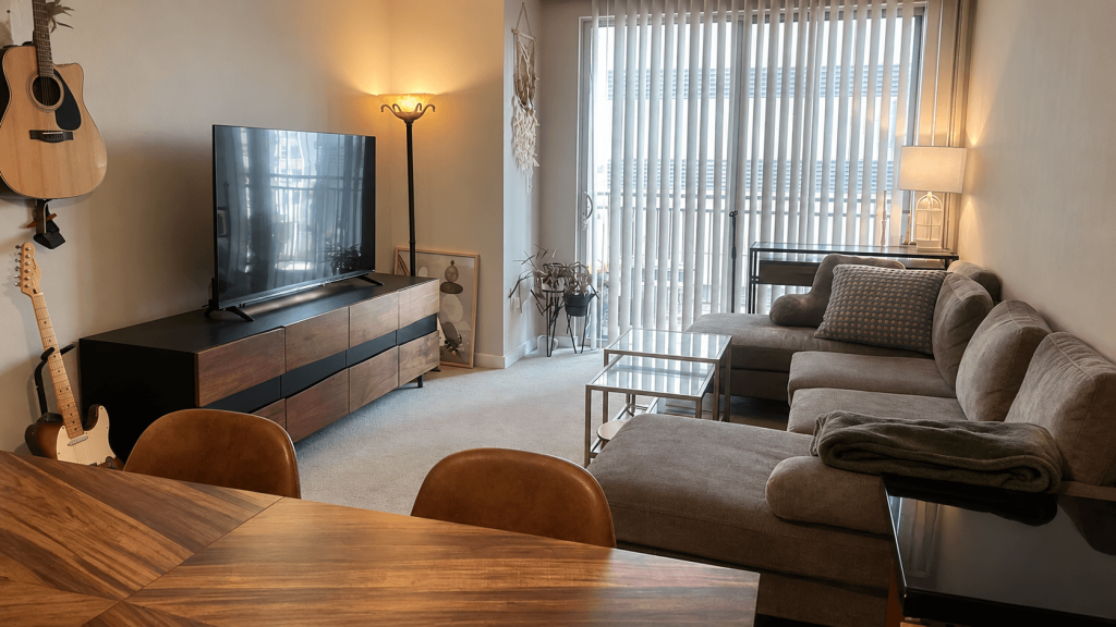 Landlord furniture dominating the view from a rental living room doorway