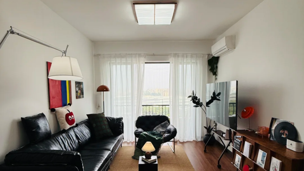 Dark seating area away from the main ceiling light in a rental room